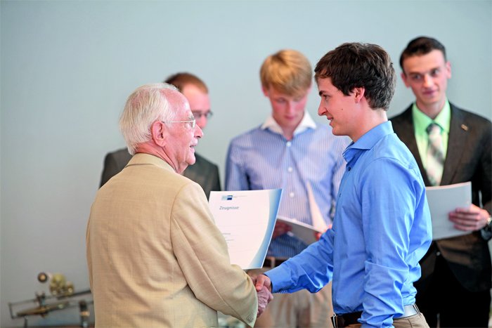 Walter Lange hands the diplomas over to the graduates.