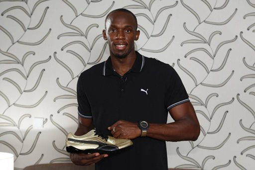 Usain Bolt showing off his matching shoe and watch strap
